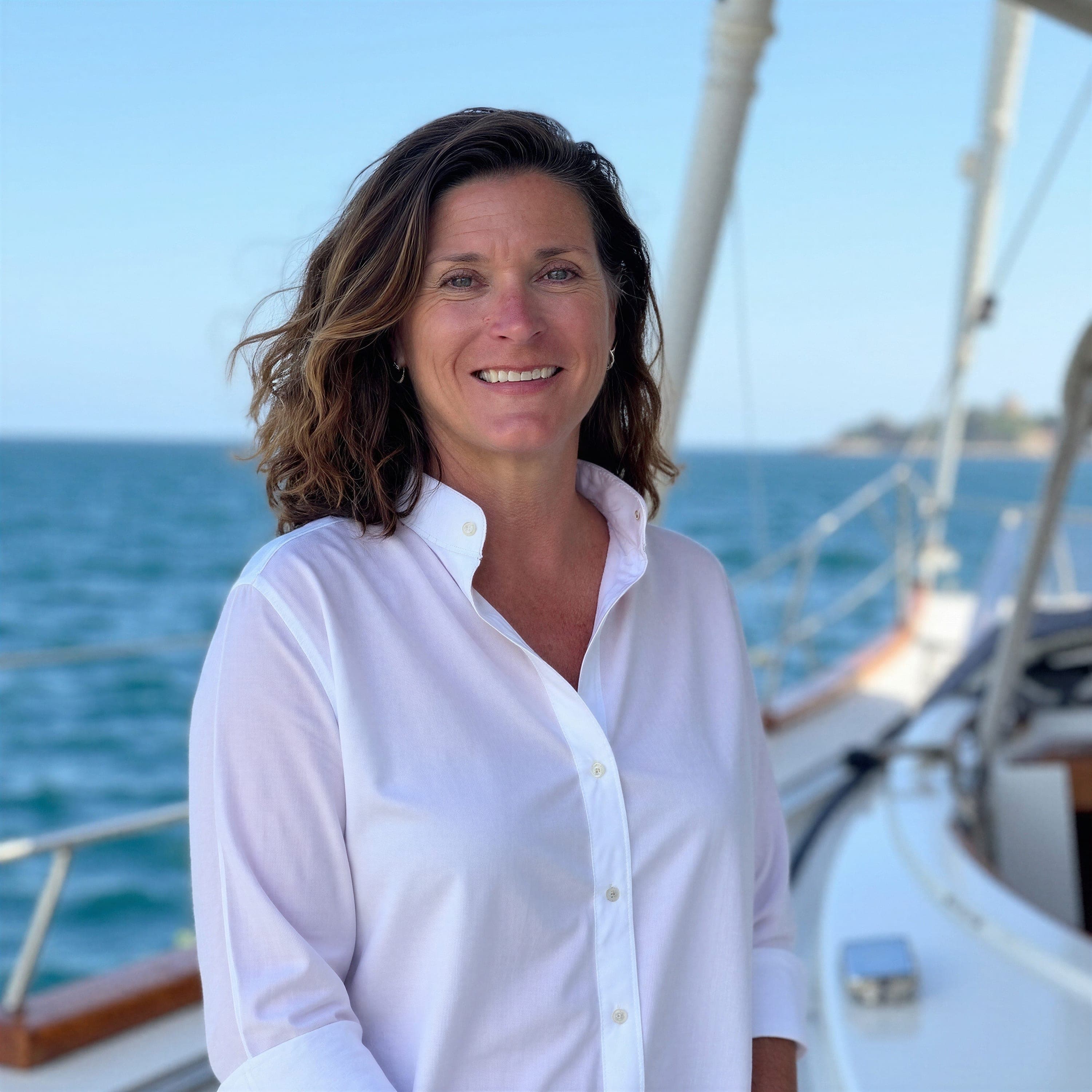 Kathryn Chadwick, lead advisor at Chadwick Global Travel Advisory, aboard a sailboat on open water.